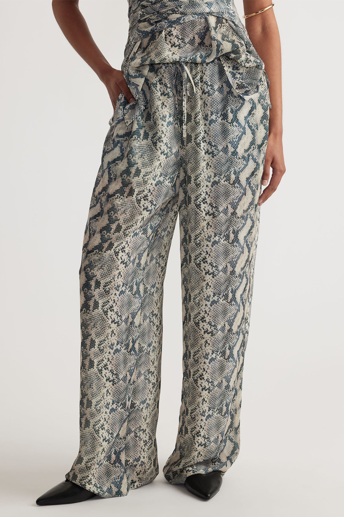 Ilaria Yoryu Pant in gallery 2 with snake print, elastic waistband, drawcord, side pockets, and relaxed fit.