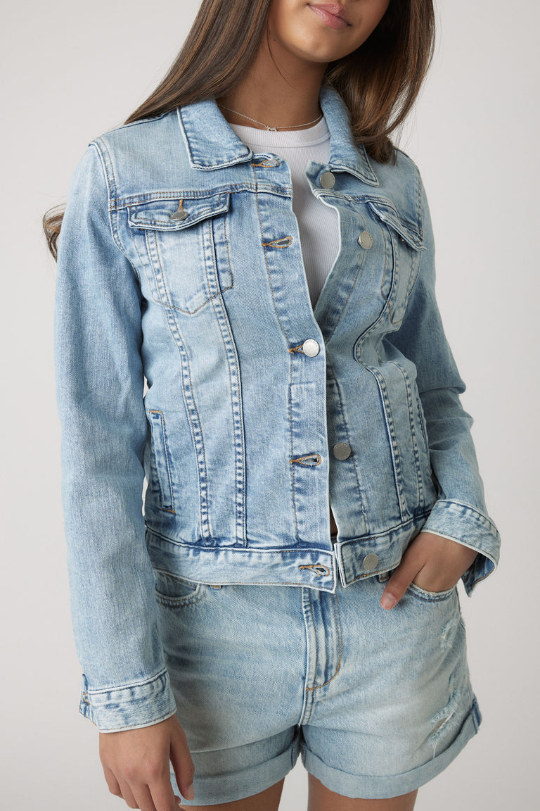 Light washed denim jacket styled with matching rolled-hem shorts for a relaxed, youthful casual look.