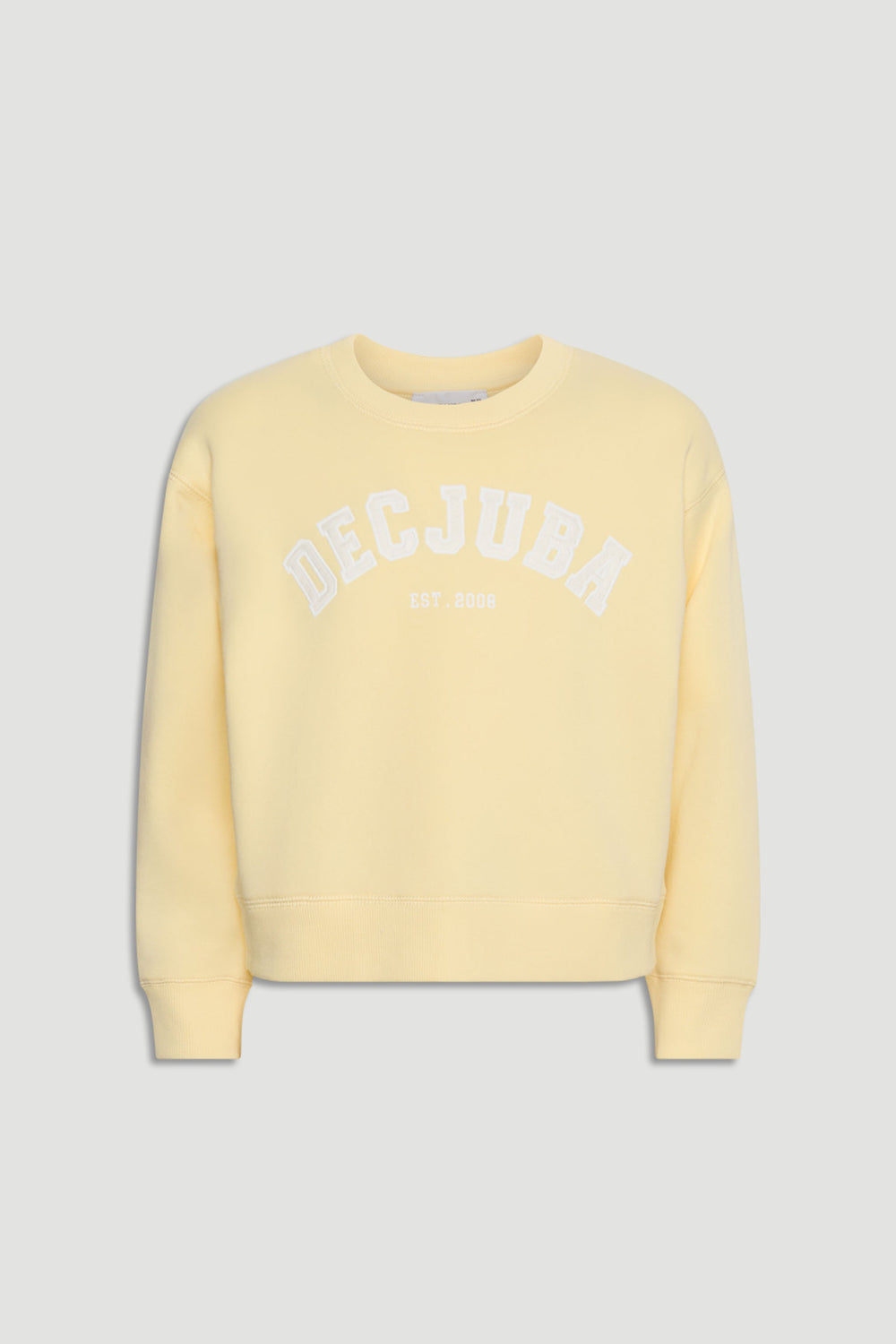 Soft yellow girls' sweatshirt with white logo text across the chest, featuring a relaxed fit and ribbed cuffs.