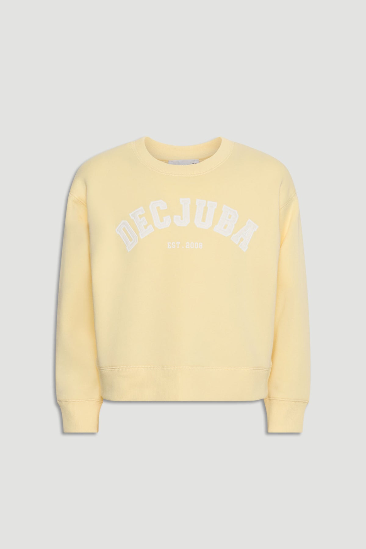 Soft yellow girls' sweatshirt with white logo text across the chest, featuring a relaxed fit and ribbed cuffs.