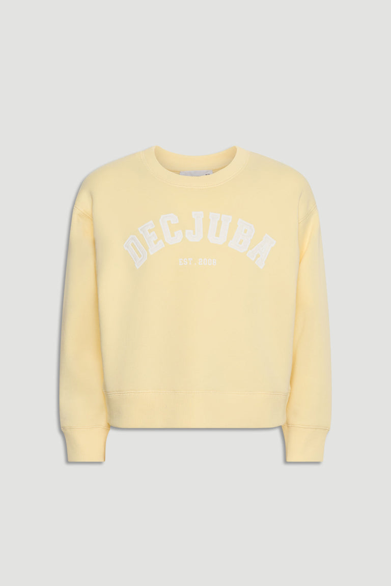 Soft yellow girls' sweatshirt with white logo text across the chest, featuring a relaxed fit and ribbed cuffs.