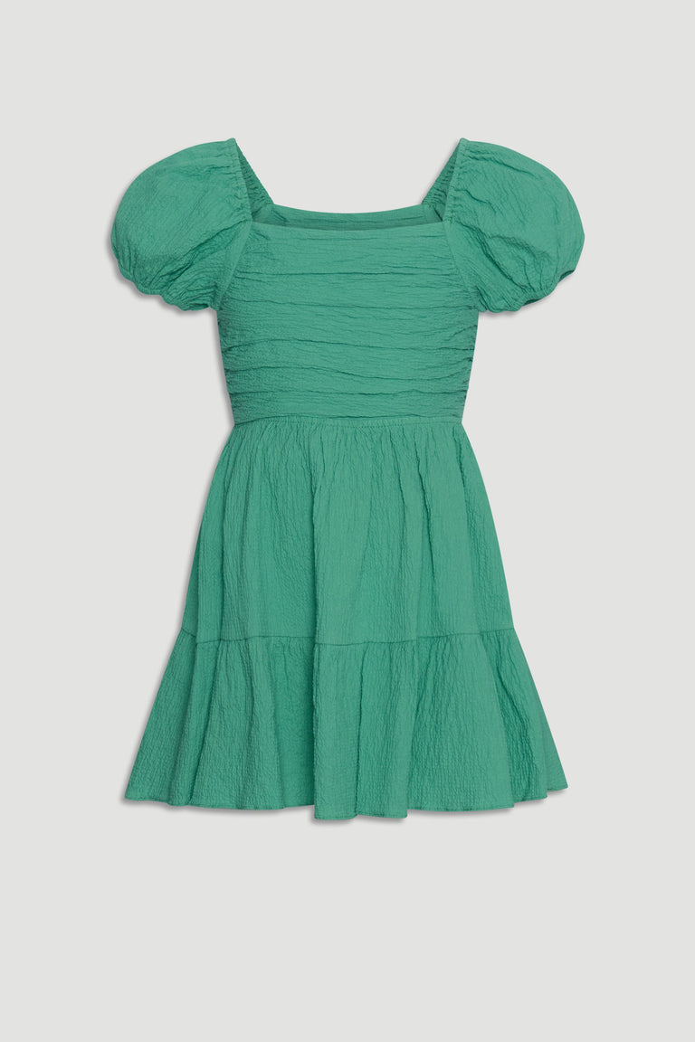 Girls textured mini dress in spring green with puff sleeves and a tiered skirt for playful everyday style.