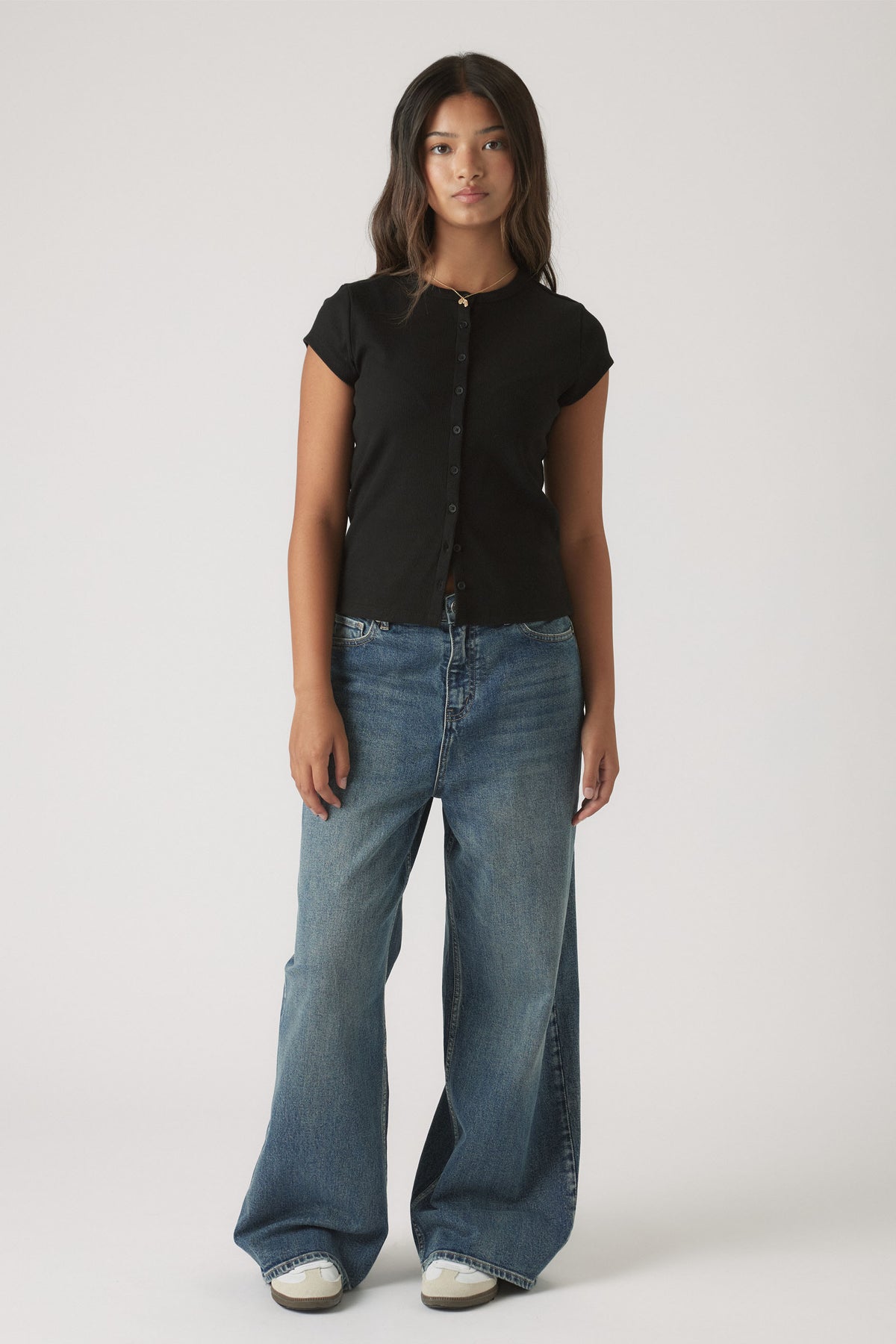 Girls Riley Rib T-Shirt in black ribbed fabric styled with wide-leg blue denim jeans by DECJUBA Australian fashion brand