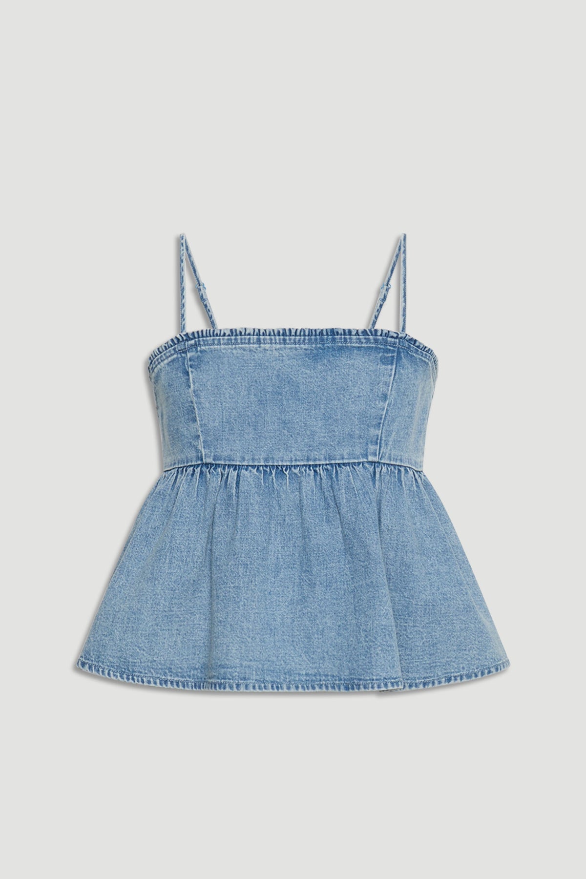 Light blue denim girls top with spaghetti straps and a flared, gathered peplum hem for casual style.