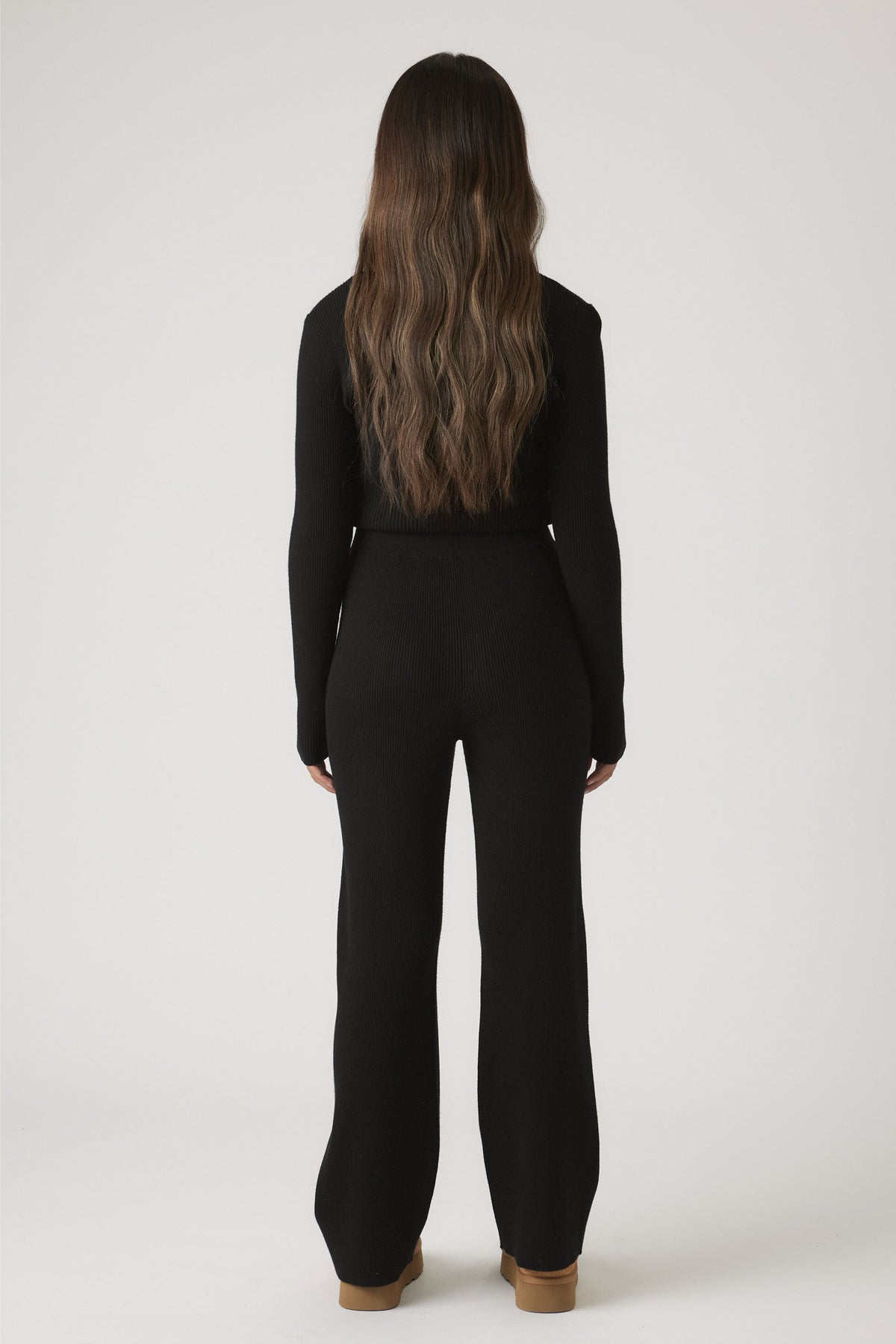 Girls Matilda Knit Pant in black ribbed knitwear with a relaxed fit, styled with tan boots by DECJUBA Australian fashion brand