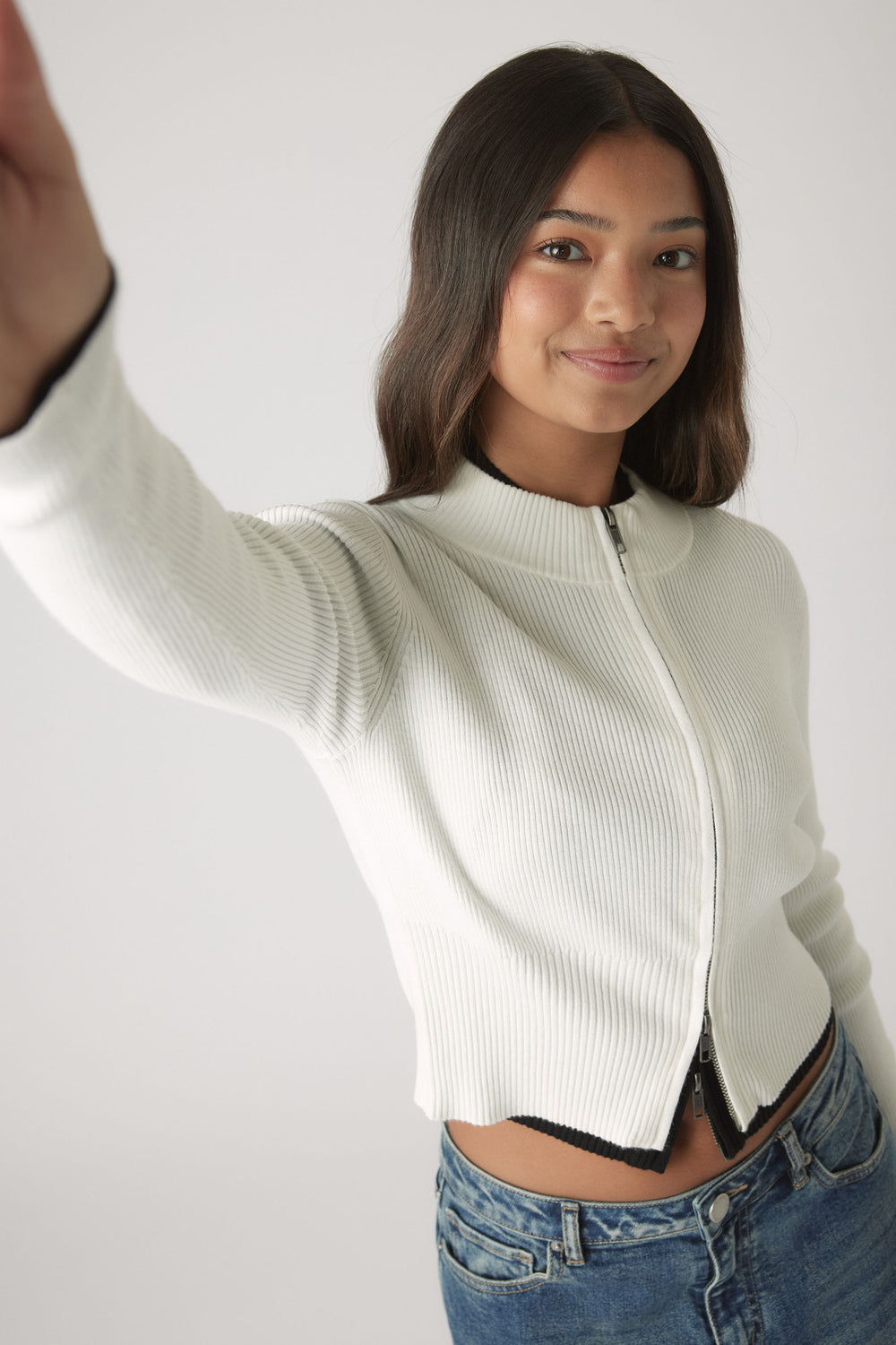 Girls Matilda Zip Up Knit in white ribbed knitwear with zip closure, styled with casual blue denim by DECJUBA Australian fashion brand