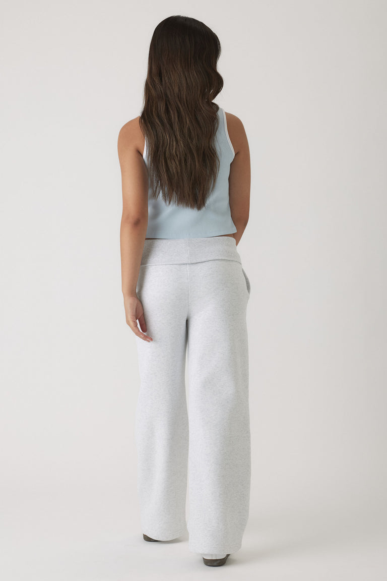Young girl shown from behind wearing a pale blue cropped tank paired with relaxed light grey wide-leg pants