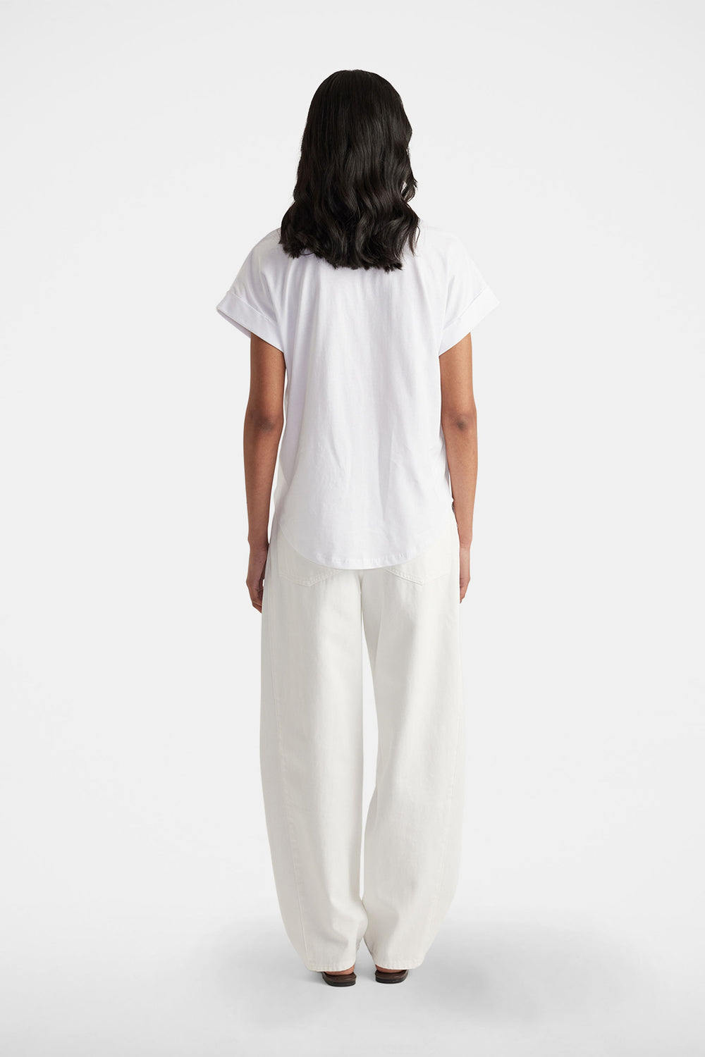Chloe Crew Tee in white shown from back in portrait, relaxed fit with drop shoulder and rolled cuff detail.