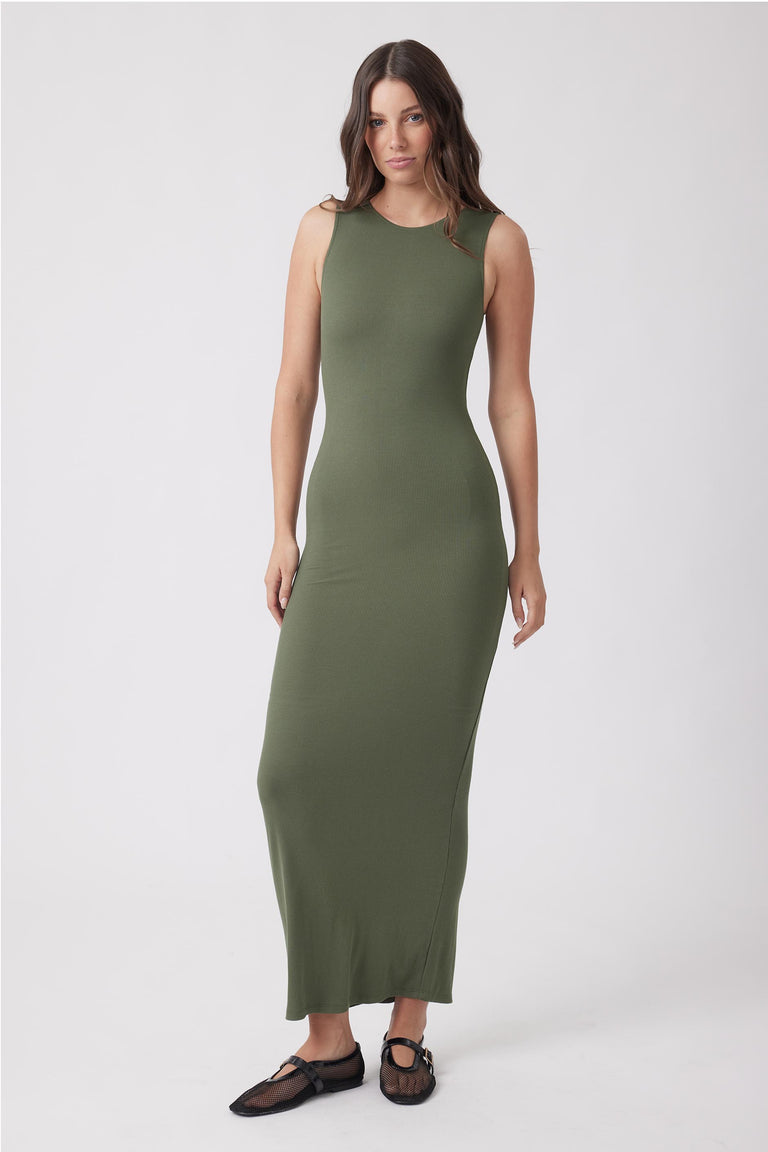 Woman wearing an olive green fitted maxi dress with a sleeveless high neckline and soft ribbed fabric