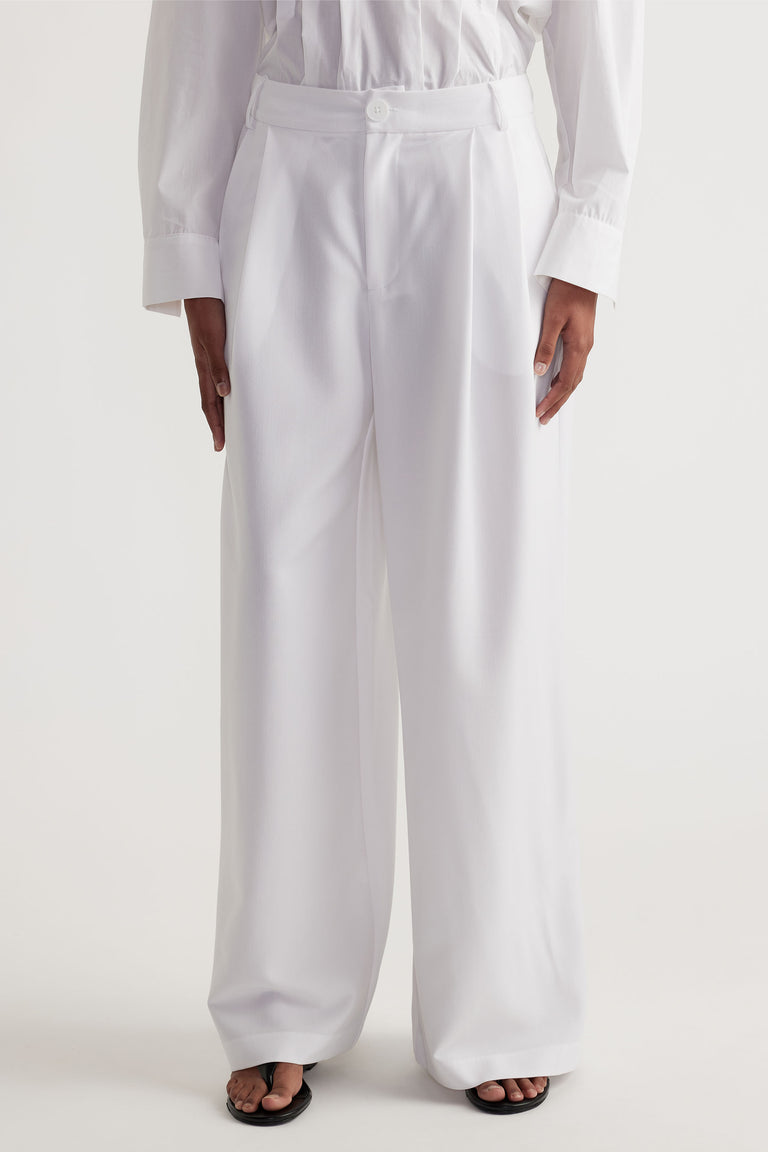 Clara Pleated Pant in white with high waist and tailored pleats, offering a relaxed wide-leg fit by DECJUBA Australian brand