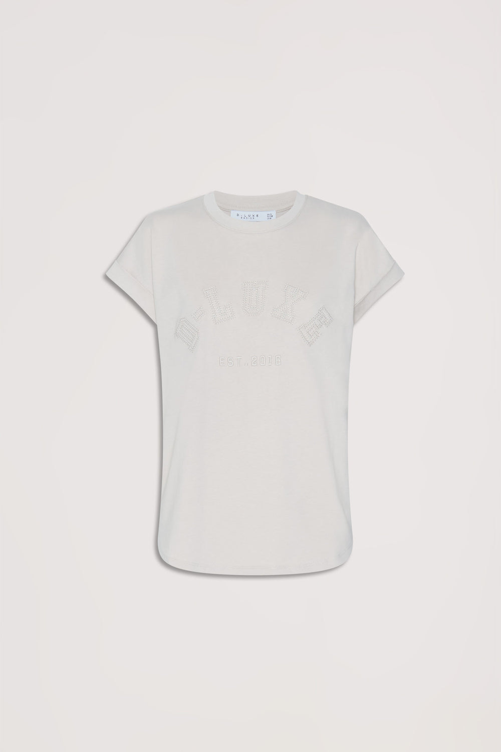 Soft shell-colored tee with subtle tonal collegiate lettering and relaxed short sleeves for casual everyday style.