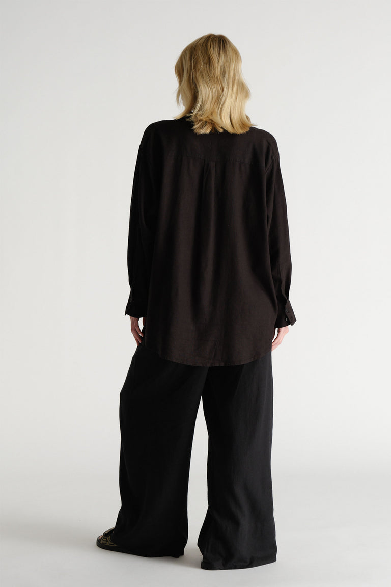 D-Luxe Linen Blend Pant in black, shown from back in portrait with relaxed fit and breathable linen fabric.