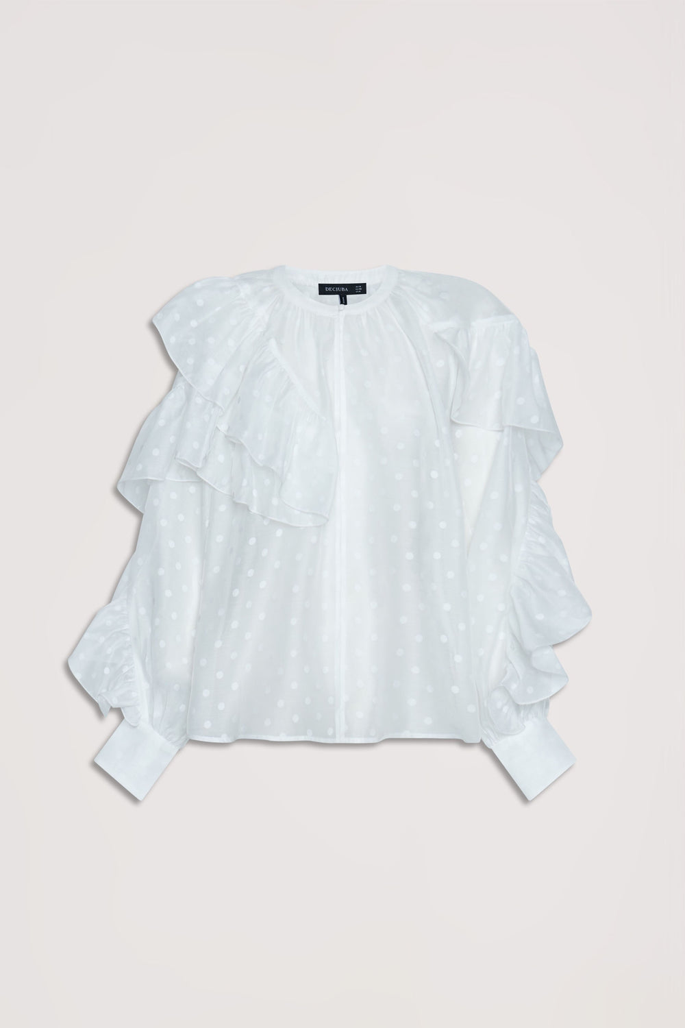 White spot patterned top featuring layered ruffle details and gathered cuffs for a delicate feminine look