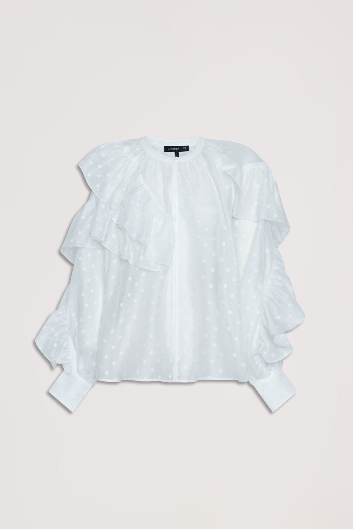 White spot patterned top featuring layered ruffle details and gathered cuffs for a delicate feminine look