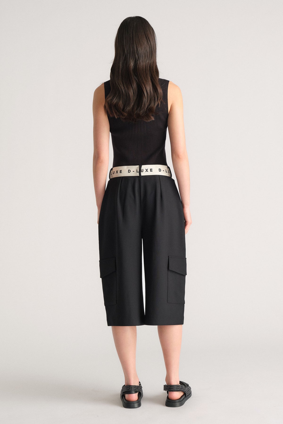 Rear view of model wearing D-Luxe Logo Waistband Short with cargo pockets, showcasing branded contrast waistband in portrait gallery 3.