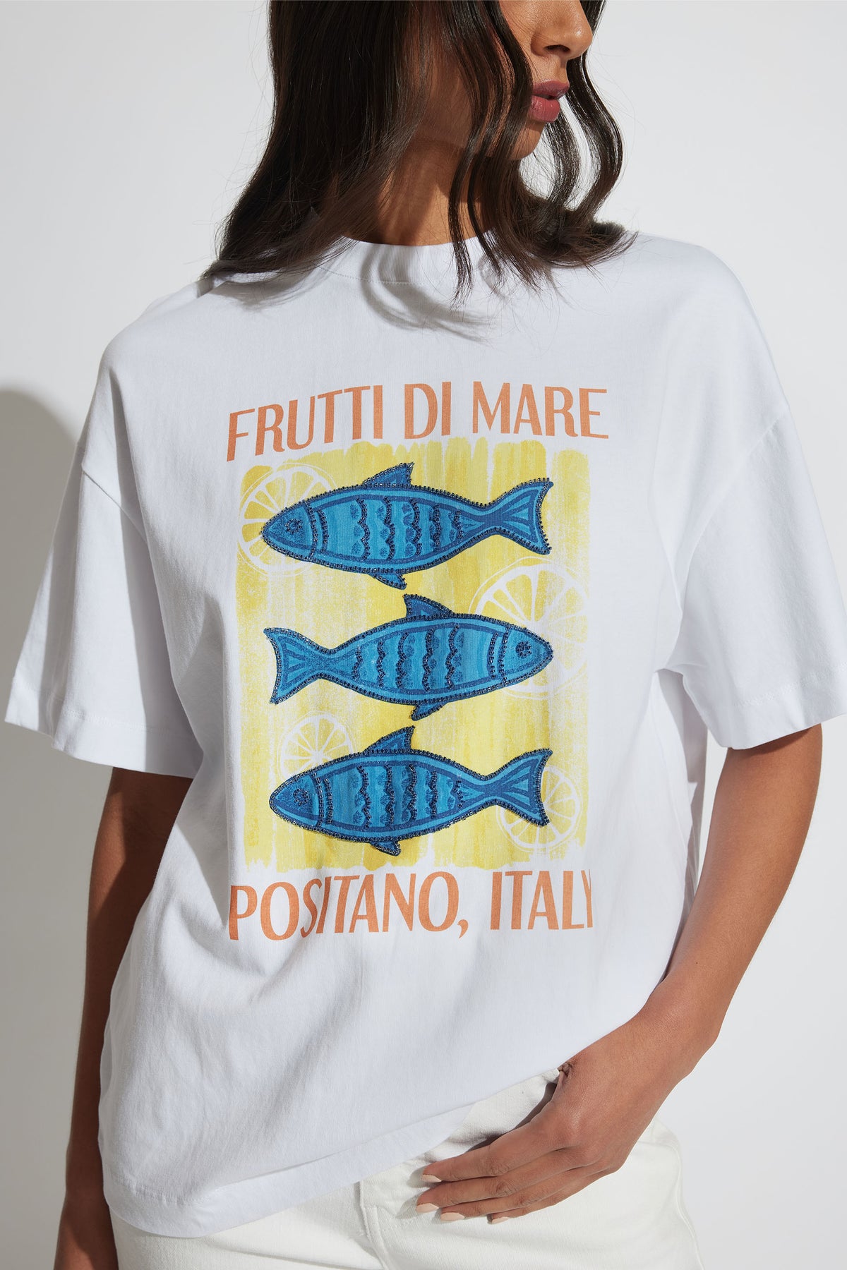 Coastal Beaded Tee front view with blue fish graphic and bead detailing on oversized white cotton t-shirt.