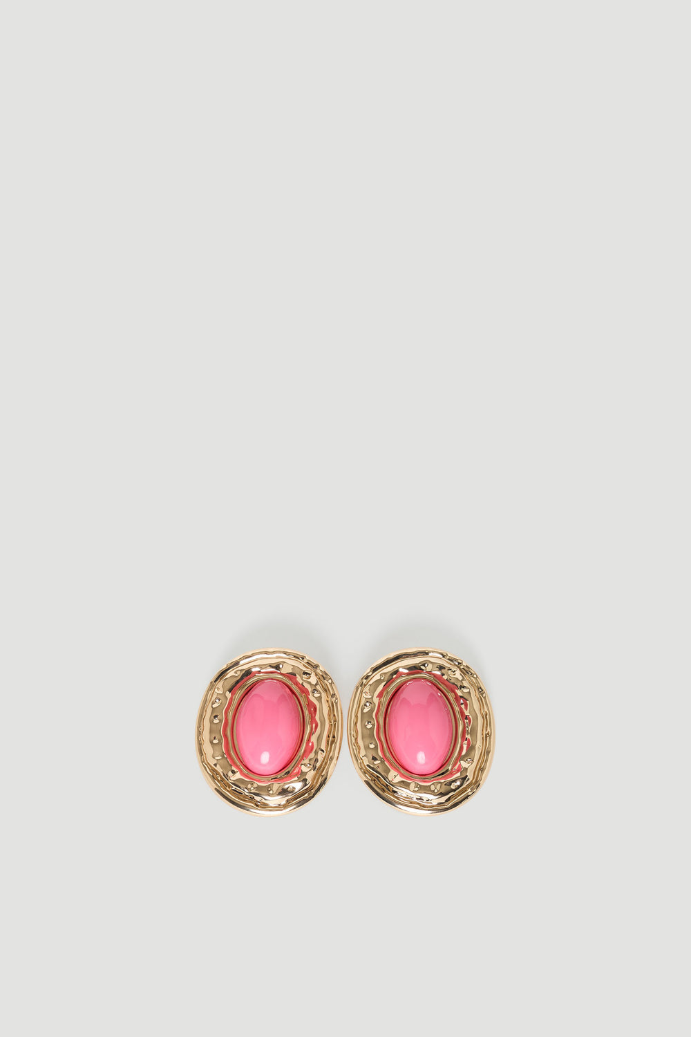 Pair of gold-tone earrings featuring bold pink stone centers with textured circular frames for a stylish accent.