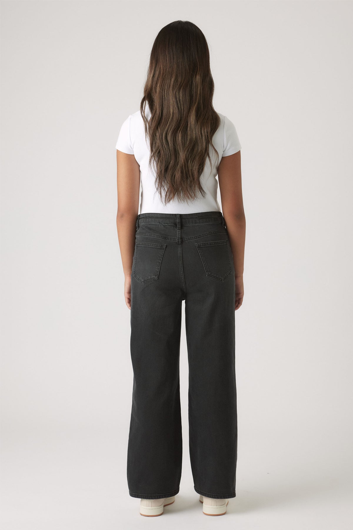 Back view of Girls Hailey Wide Leg Jean in black denim with a comfortable high waist and relaxed wide leg fit by Decjuba.