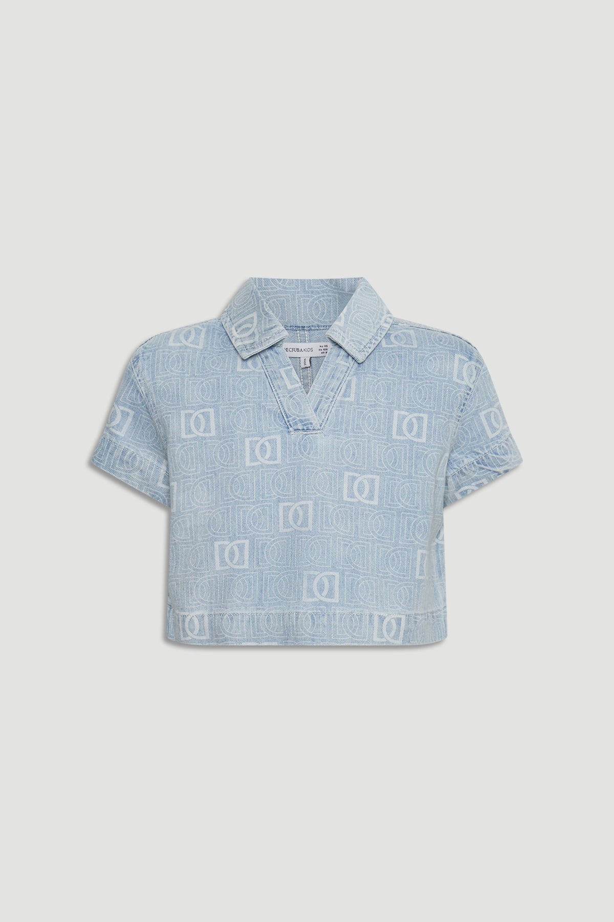Light blue cropped denim shirt for girls featuring subtle all-over monogram pattern and short sleeves.