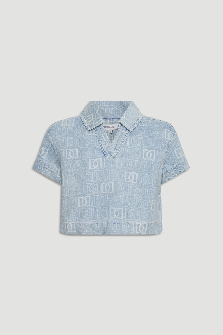 Light blue cropped denim shirt for girls featuring subtle all-over monogram pattern and short sleeves.