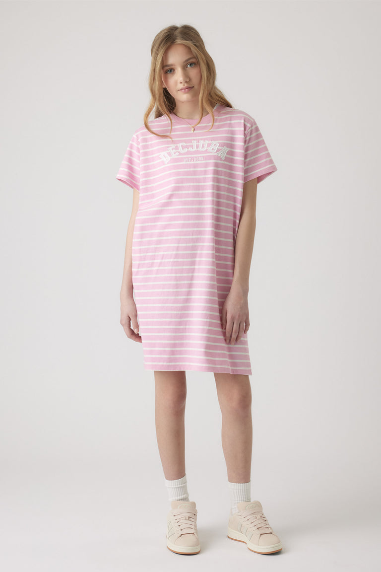 Teen girl wearing a relaxed pink and white striped rugby tee dress paired with socks and light sneakers for casual style