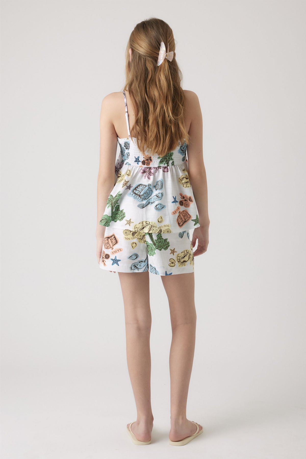 Back view of girl wearing Girls Millie Beach Short with elasticated waistband and colorful print, gallery position 3.