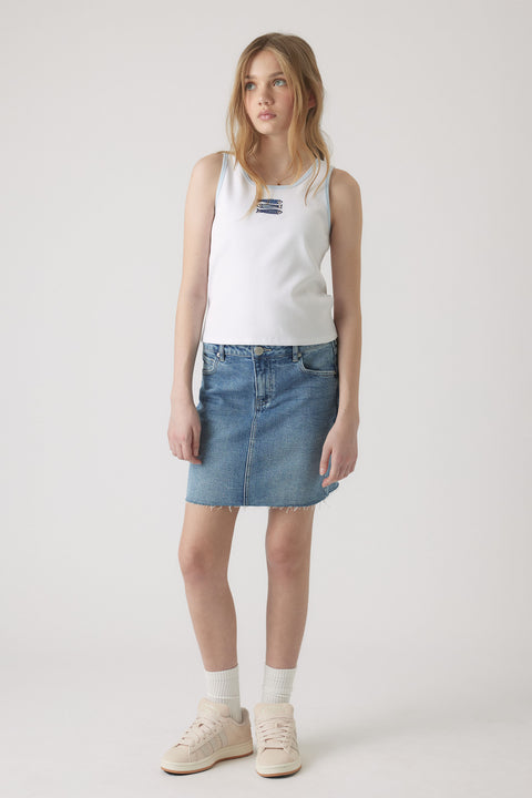 Girl wearing a white embroidered tank top paired with a casual blue denim skirt and light sneakers