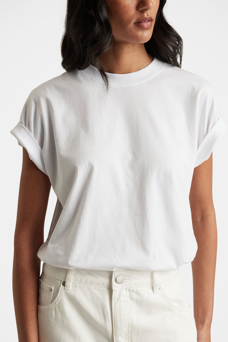 Close-up portrait of a woman wearing a white Chloe Crew Tee with rolled cuffs in gallery position 2, portrait orientation