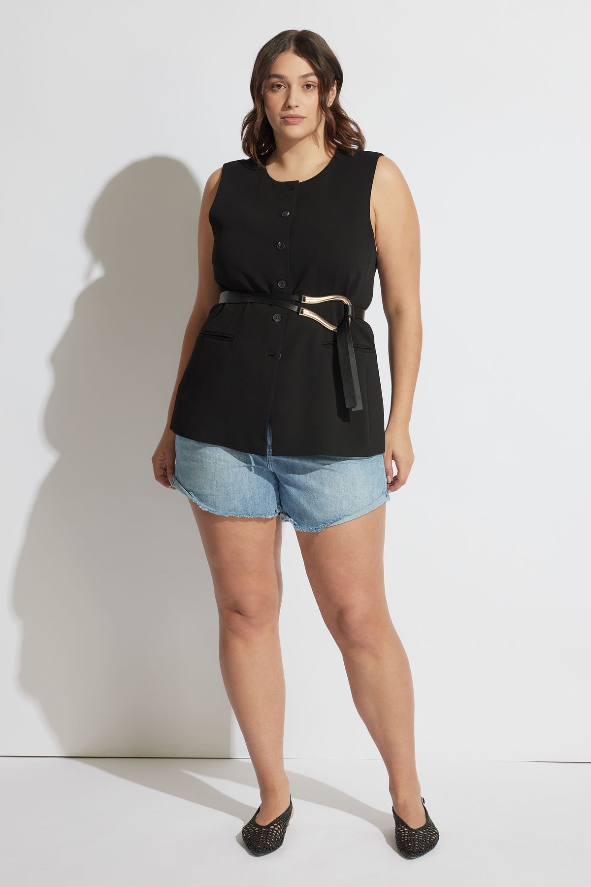 Woman wearing Harper Rolled Cuff Denim Short in light wash with black sleeveless top, front view, gallery position 4 portrait