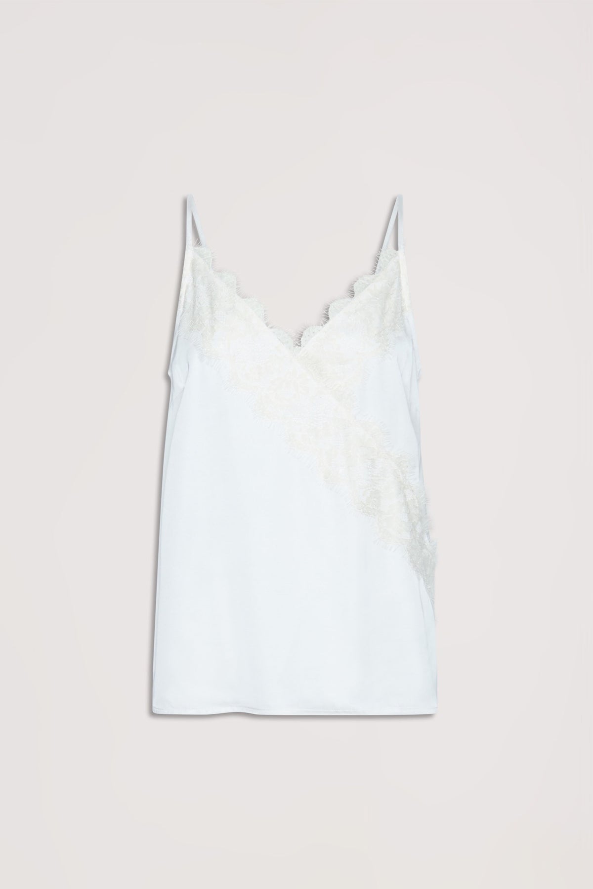 White cami top with delicate lace trim along the neckline and diagonal front, featuring thin straps.