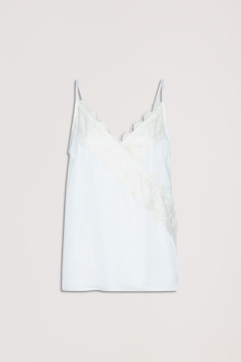 White cami top with delicate lace trim along the neckline and diagonal front, featuring thin straps.