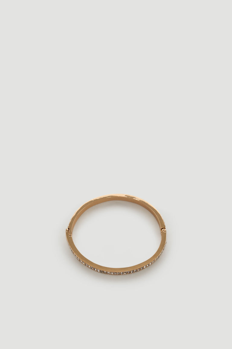 Gold-toned bracelet with a sleek band featuring a row of small sparkling diamante accents for an elegant touch.