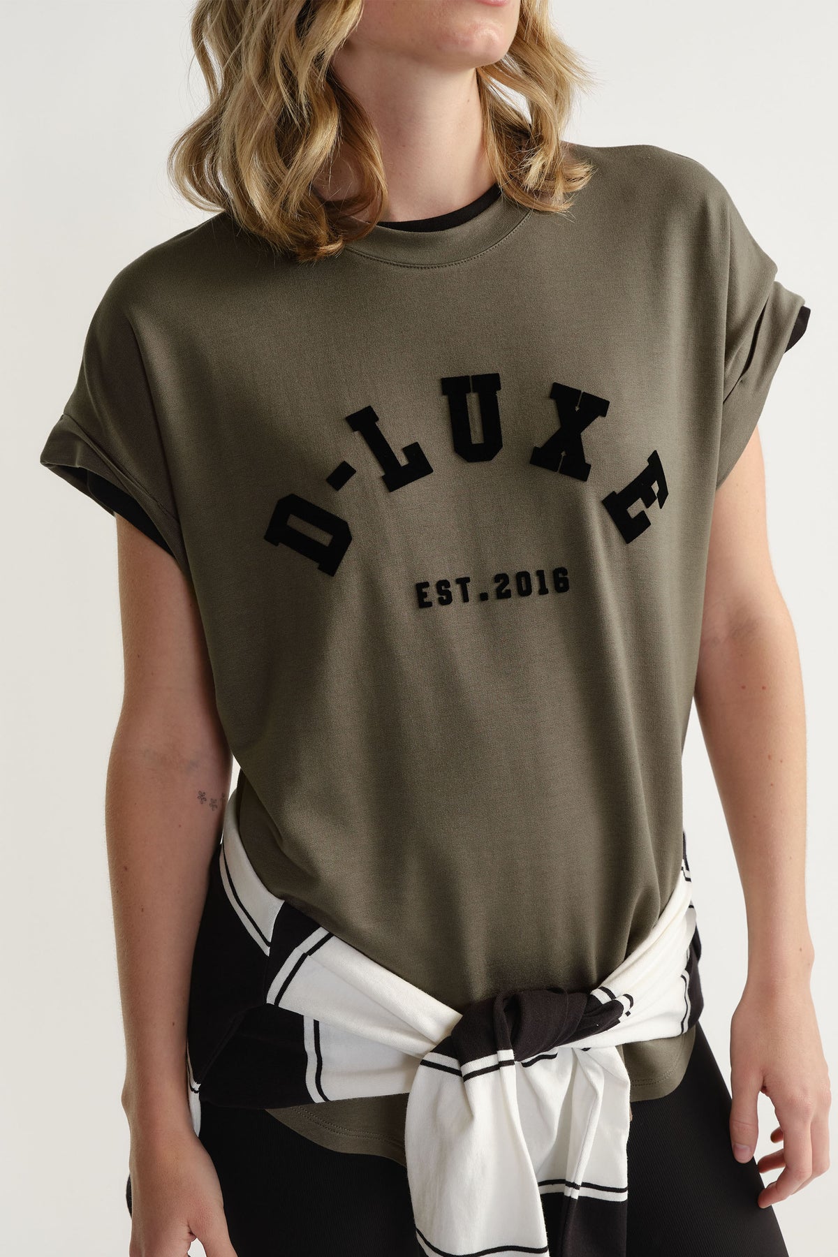 Portrait of model wearing D-Luxe Half Moon Tee with flocked branding and rolled sleeves, gallery position 2, 1880x2820.