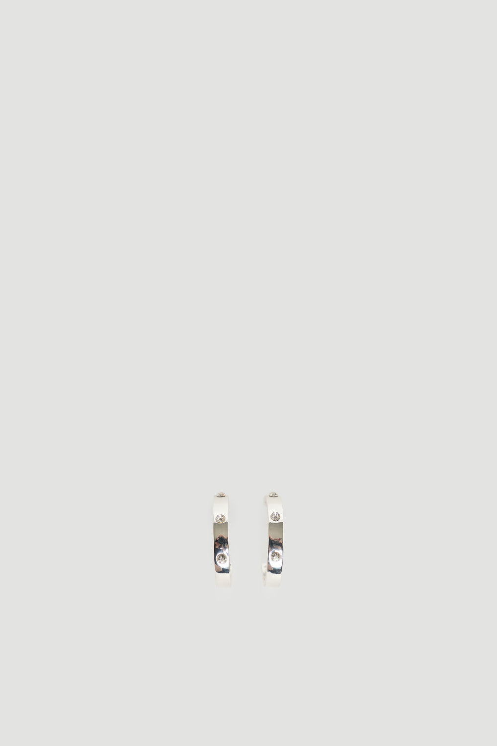 Small silver hoop earrings featuring subtle sparkling diamante accents for a refined, elegant style