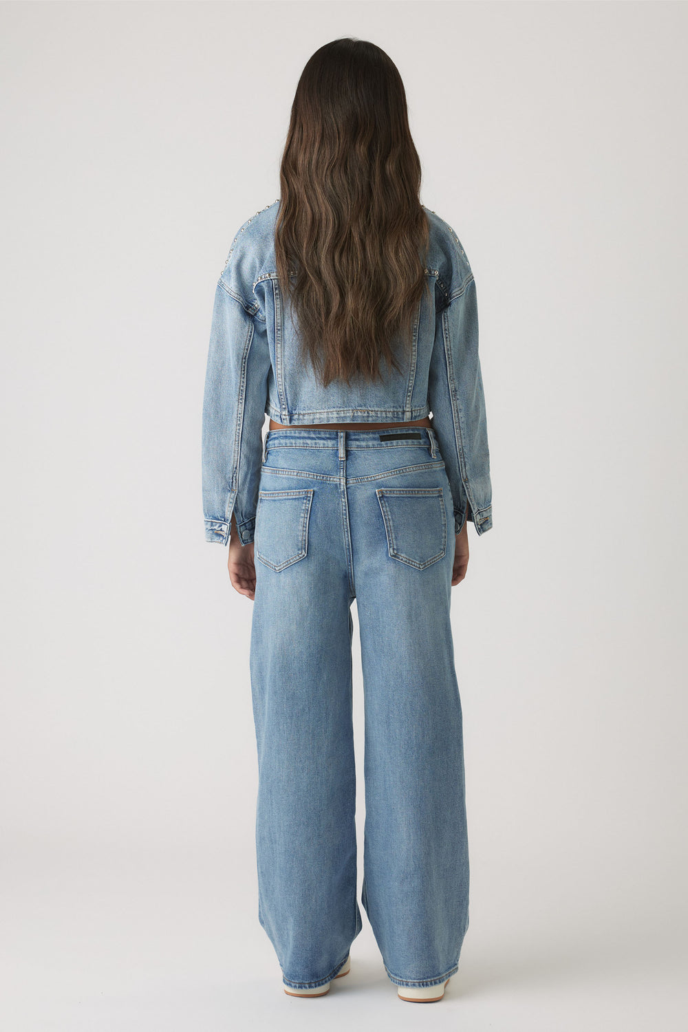 Back view of Girls Hailey Wide Leg Jean in light blue denim with relaxed fit and high waist by Decjuba Australian brand