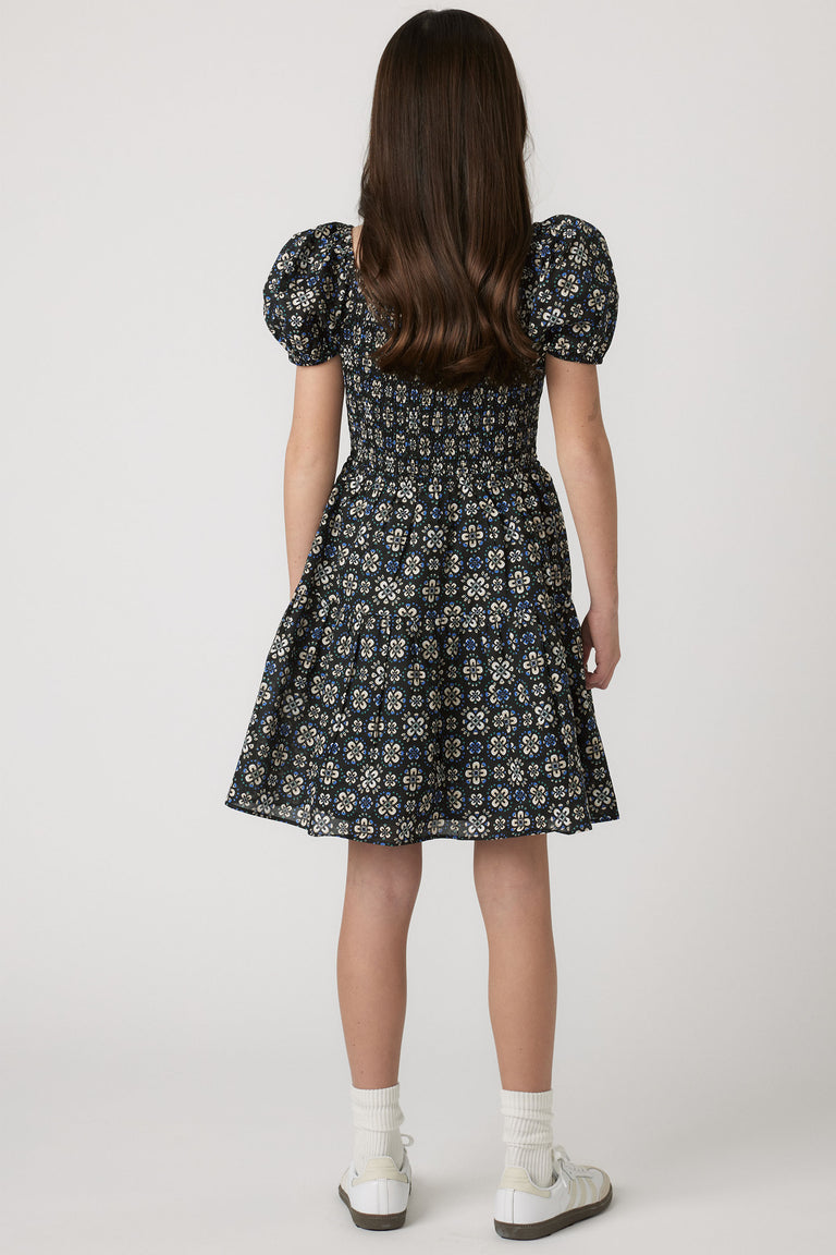 Girls Maude Mini Dress back view with short balloon sleeves and flowy skirt in a floral print, gallery position 2 portrait