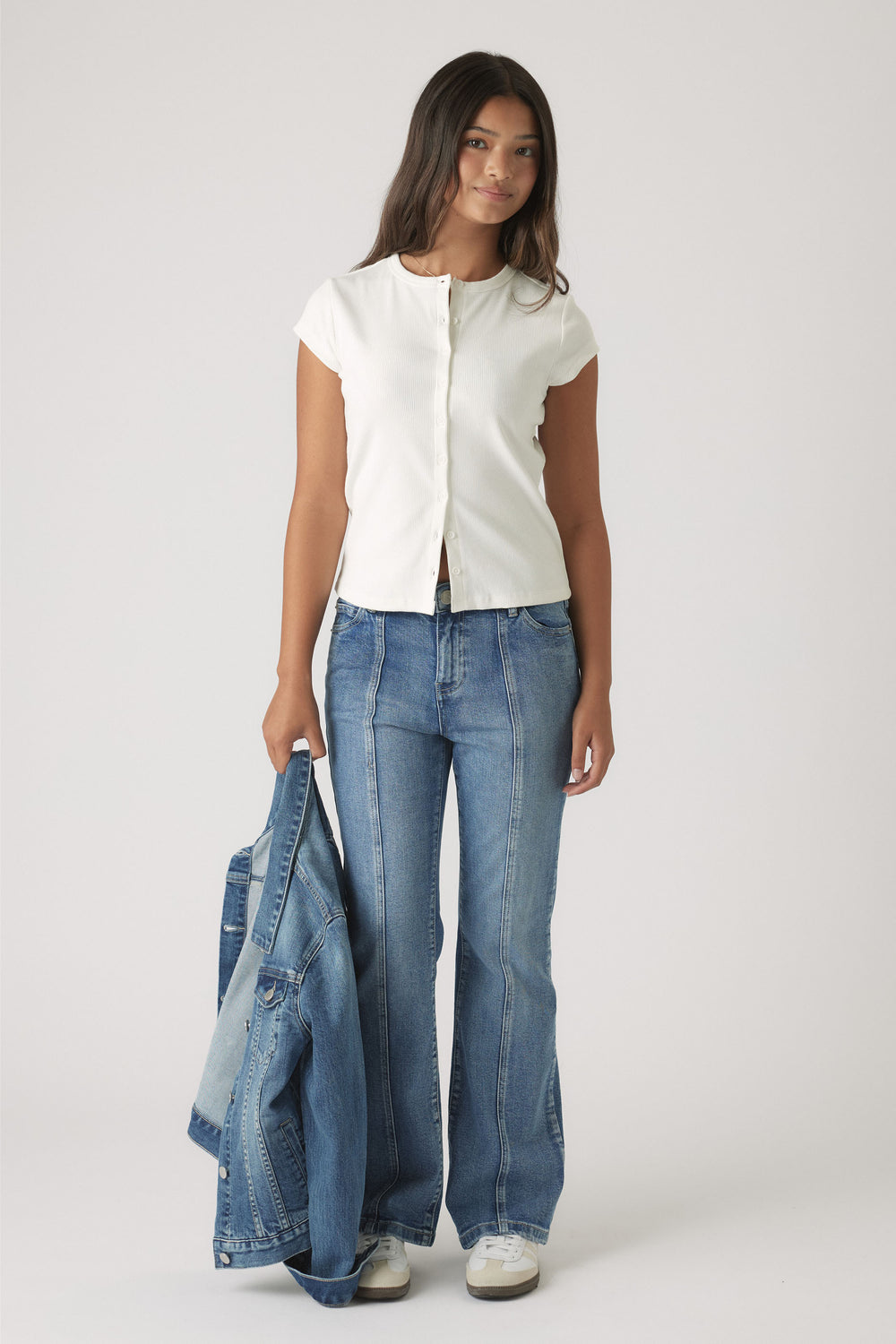 Girls Riley Rib T-Shirt in soft white fabric with front buttons, styled with flared denim jeans by DECJUBA Australian fashion brand