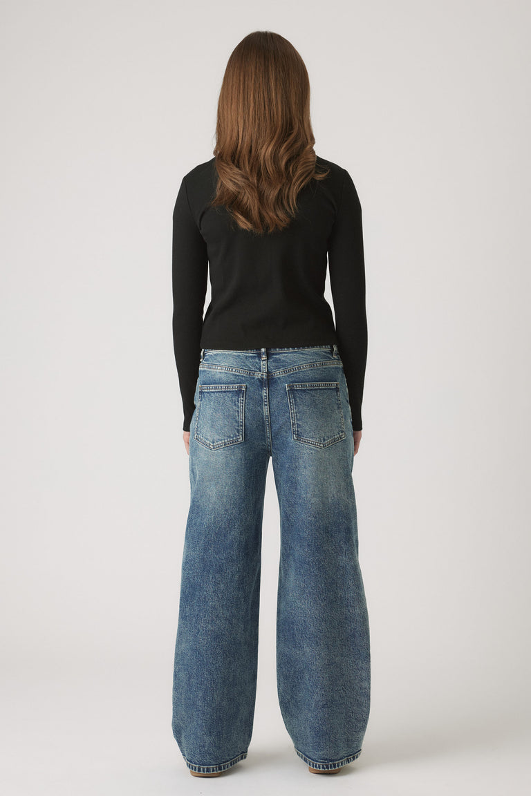 Girl wearing Girls Riley Rib Long Sleeve in black, shown in gallery position 3, portrait orientation, 1880x2820 pixels.