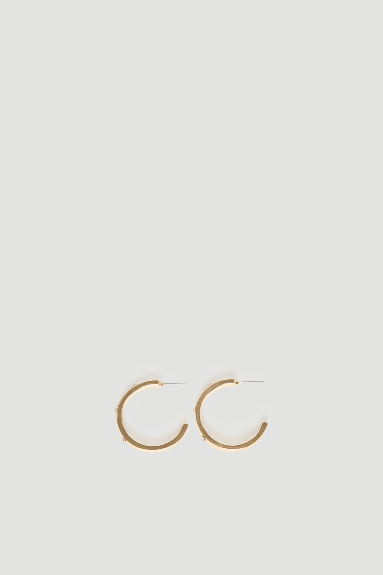 Pair of medium-sized gold hoop earrings with subtle diamante accents on a clean, light backdrop