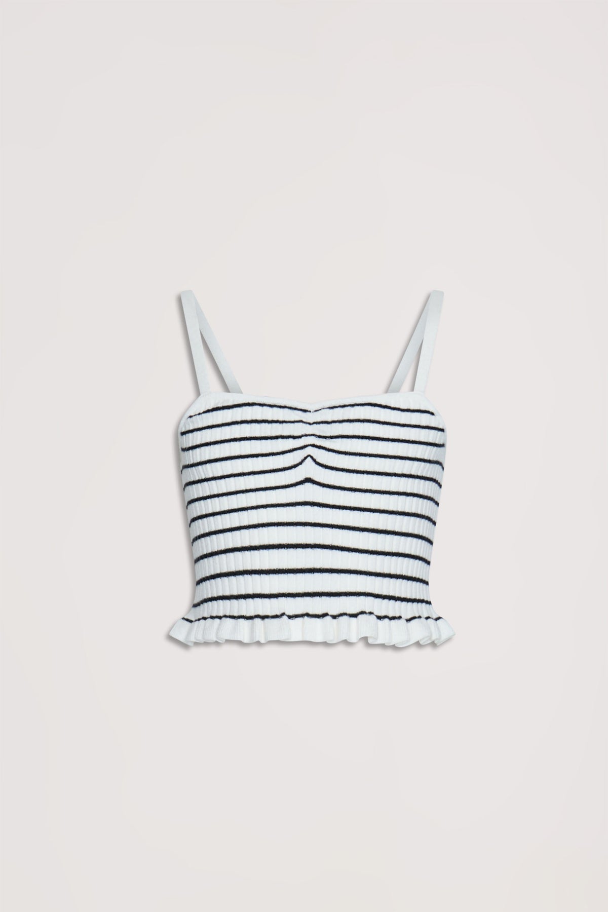 Cropped white tank top with thin straps, textured horizontal stripes, and ruffled hem for a playful, casual look.
