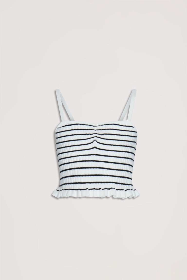 Cropped white tank top with thin straps, textured horizontal stripes, and ruffled hem for a playful, casual look.
