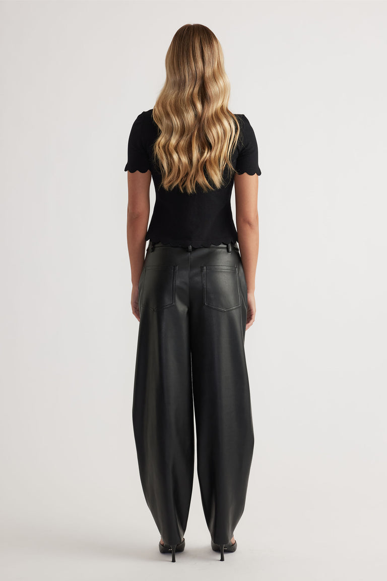 Back view of woman wearing black Kai Scallop Edge Tee in 52% LENZING™ ECOVERO™ Viscose 48% Recycled Nylon by DECJUBA Australian brand