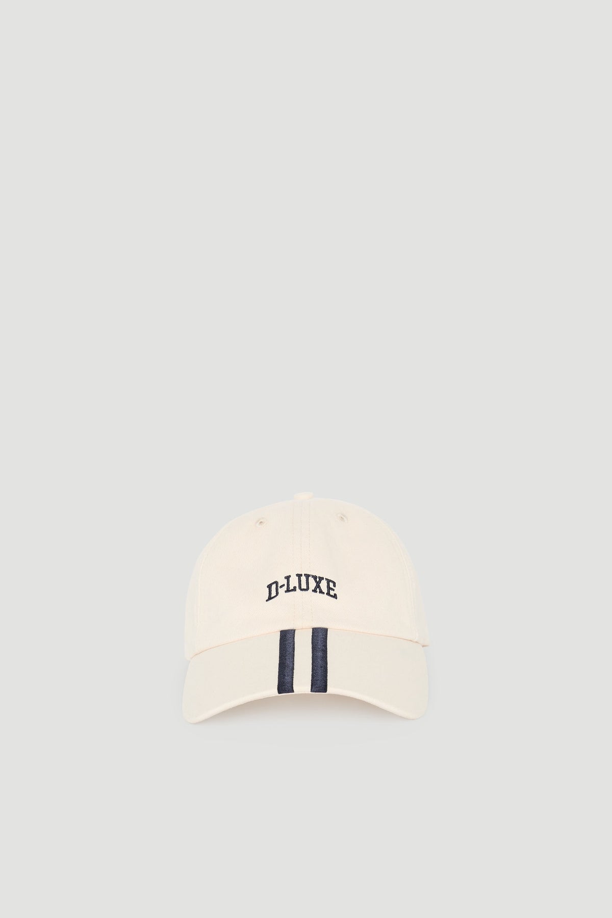 Cream-colored casual cap with navy stripe detail and embroidered D-Luxe logo for a timeless sporty look