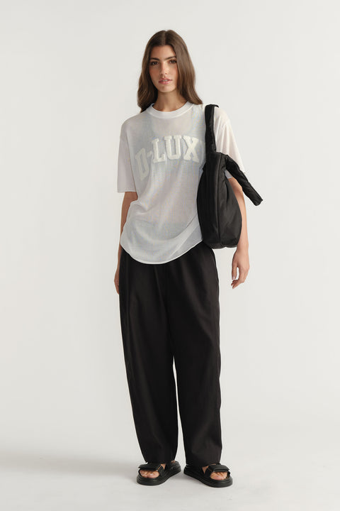 Model wearing D-Luxe Fine Knit Tee with crew neck and visible bouclé logo in portrait gallery position one.