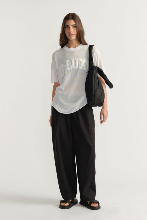Model wearing D-Luxe Fine Knit Tee with crew neck and visible bouclé logo in portrait gallery position one.