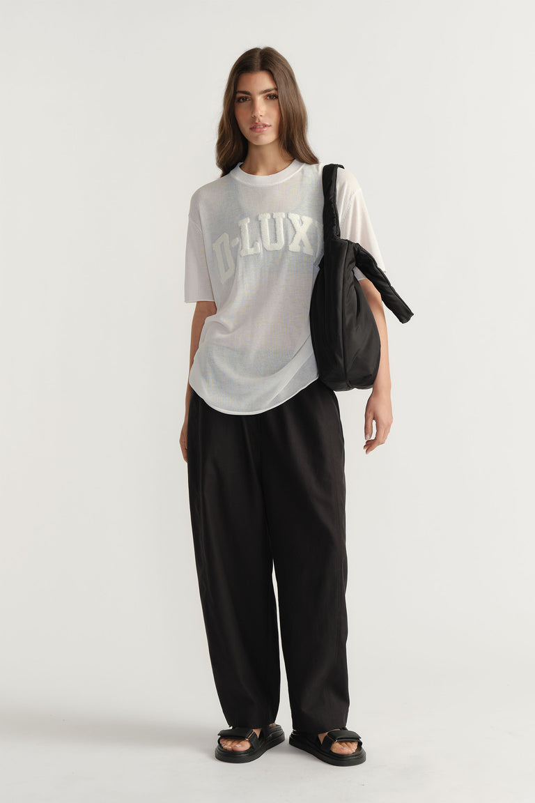 Model wearing D-Luxe Fine Knit Tee with crew neck and visible bouclé logo in portrait gallery position one.