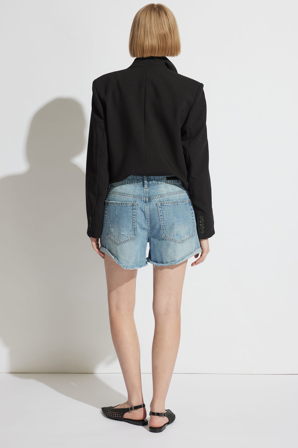 Harper Rolled Cuff Denim Short shown in gallery position 3, featuring mid-rise denim with raw edges in portrait view.