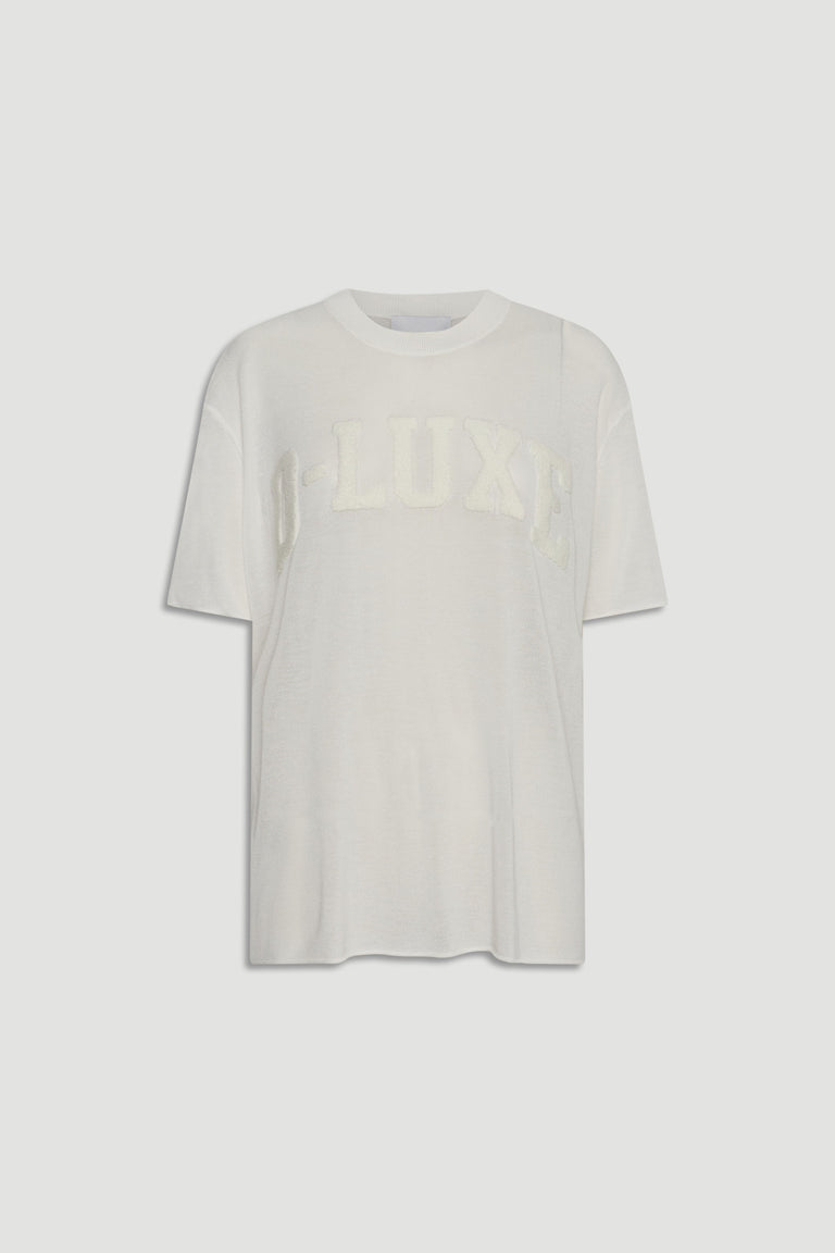 D-Luxe Fine Knit Tee in portrait, gallery position 4, white semi-sheer knitwear with boucle D-LUXE text across chest.