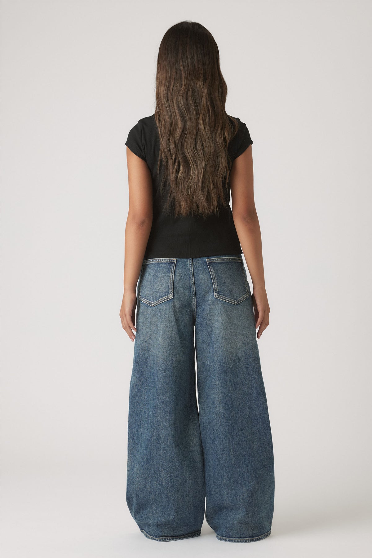 Girls Riley Rib T-Shirt in black rib fabric styled with wide-leg blue denim jeans by DECJUBA Australian fashion brand