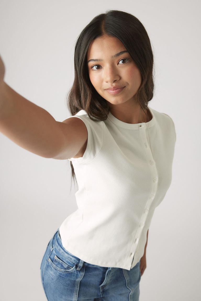Girls Riley Rib T-Shirt in soft white ribbed fabric with front buttons, styled with blue denim jeans by DECJUBA Australian brand